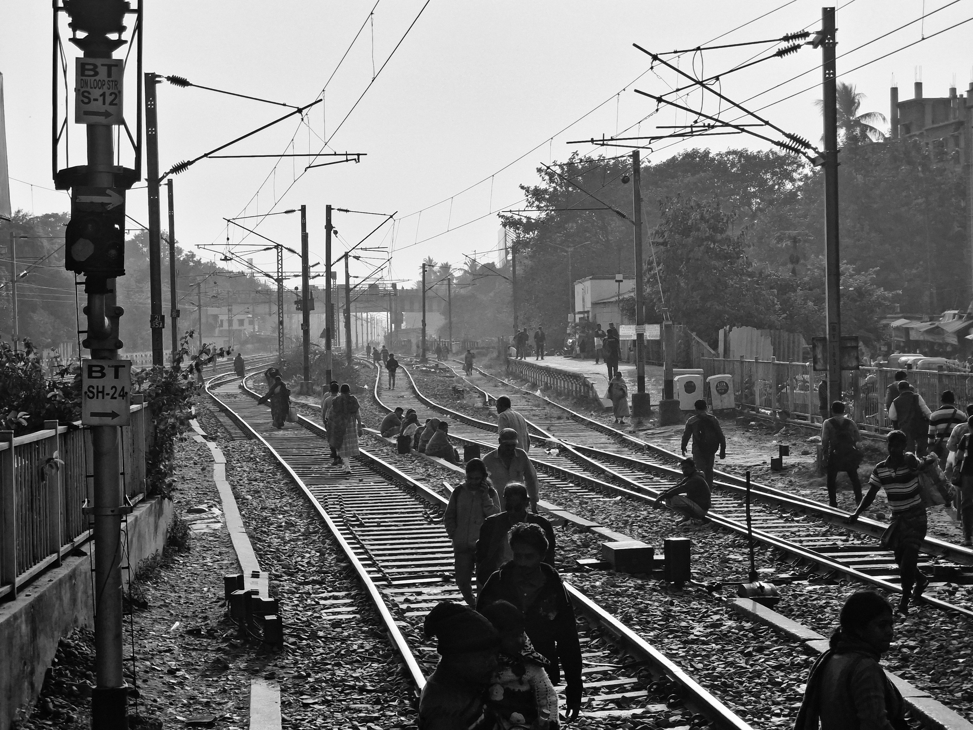 Commuters crossing outside Churchgate station with the Oval Maidan beyond