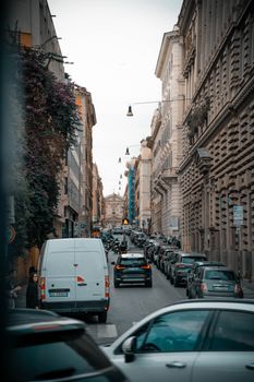 A bustling street scene in Rome showcasing historic architecture and city life.