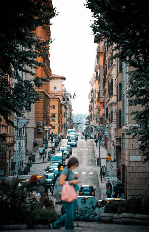 Free A lively street scene depicting a busy European city with people and traffic against historic architecture. Stock Photo