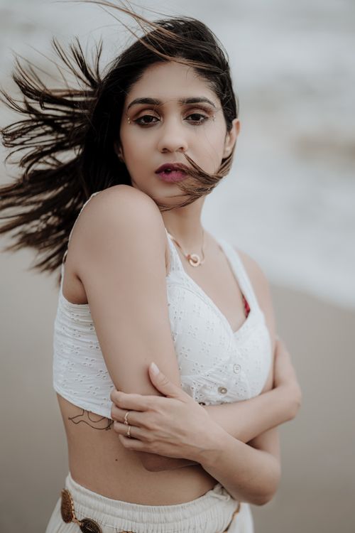 Free Captivating portrait of a woman on a windy beach in Goa, India. Stock Photo