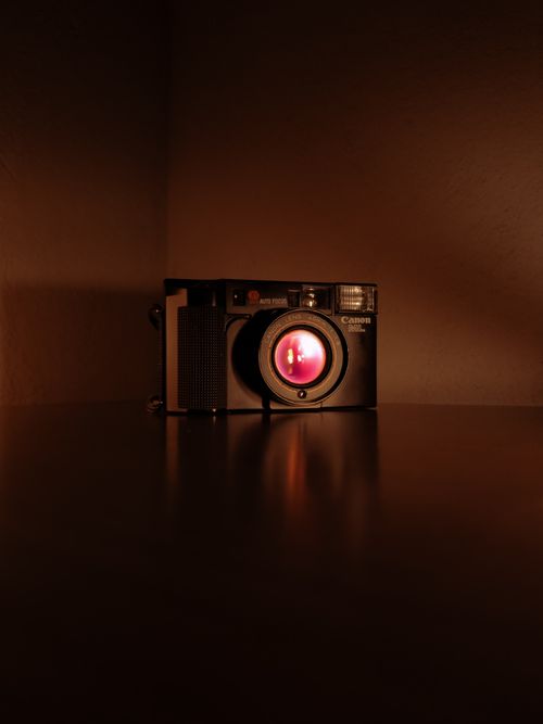 Free An artistic shot of a vintage camera with a warm, cinematic look, perfect for retro-themed projects. Stock Photo