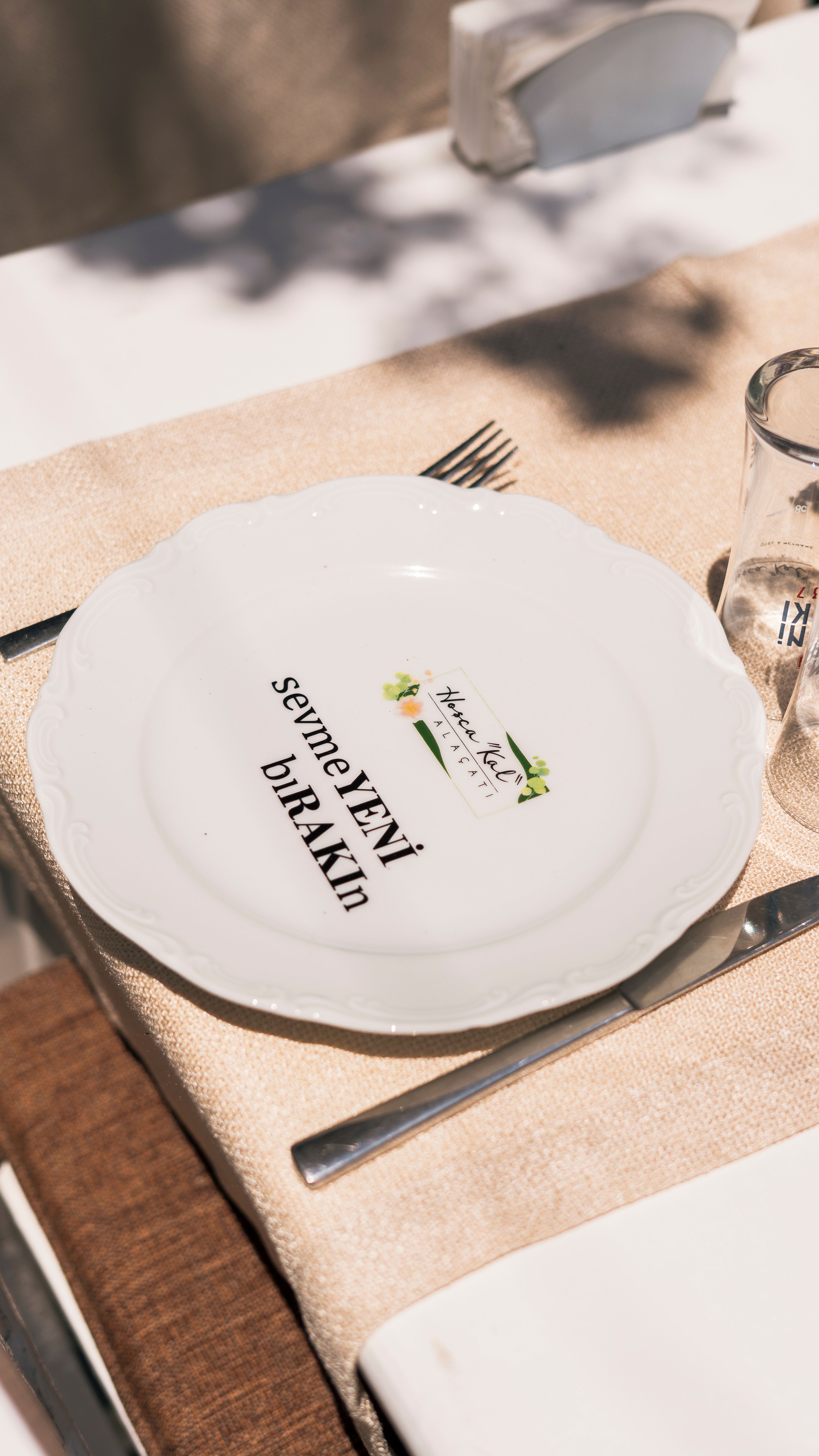 Chic outdoor dining arrangement featuring a decorative plate with text.