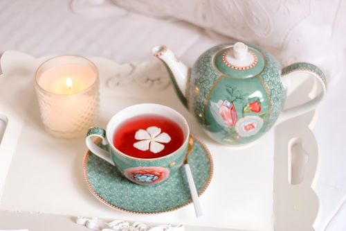 Free A stylish floral tea set with candle on a decorative tray, creating a cozy atmosphere. Stock Photo