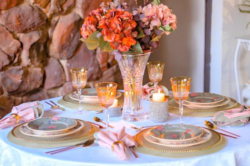 Free Beautifully arranged dining table with floral centerpiece, perfect for special occasions. Stock Photo