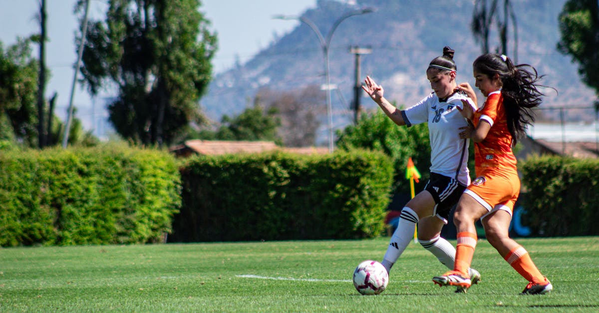 Intense soccer match between female athletes on a green field in Chile.