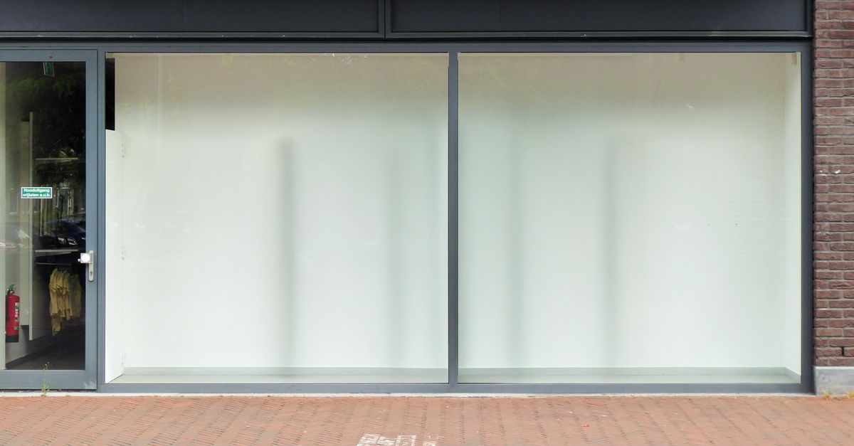 Clean modern storefront with large glass windows, perfect for retail display.