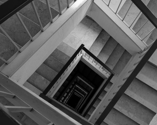 Free A captivating black and white image of a spiral staircase, offering a geometric architectural perspective. Stock Photo