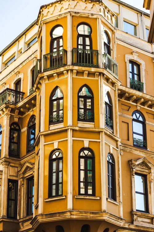 Free Ornate building facade with arched windows and vibrant colors. Stock Photo