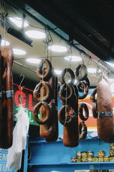 A colorful display of sausages hanging in a local butcher shop, showcasing cured meats.
