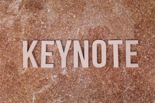 Wooden letters spelling 'KEYNOTE' on a textured stone surface, ideal for presentations.