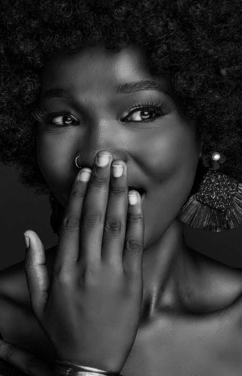 Free Stunning close-up of a woman's joyful expression in black and white. Stock Photo