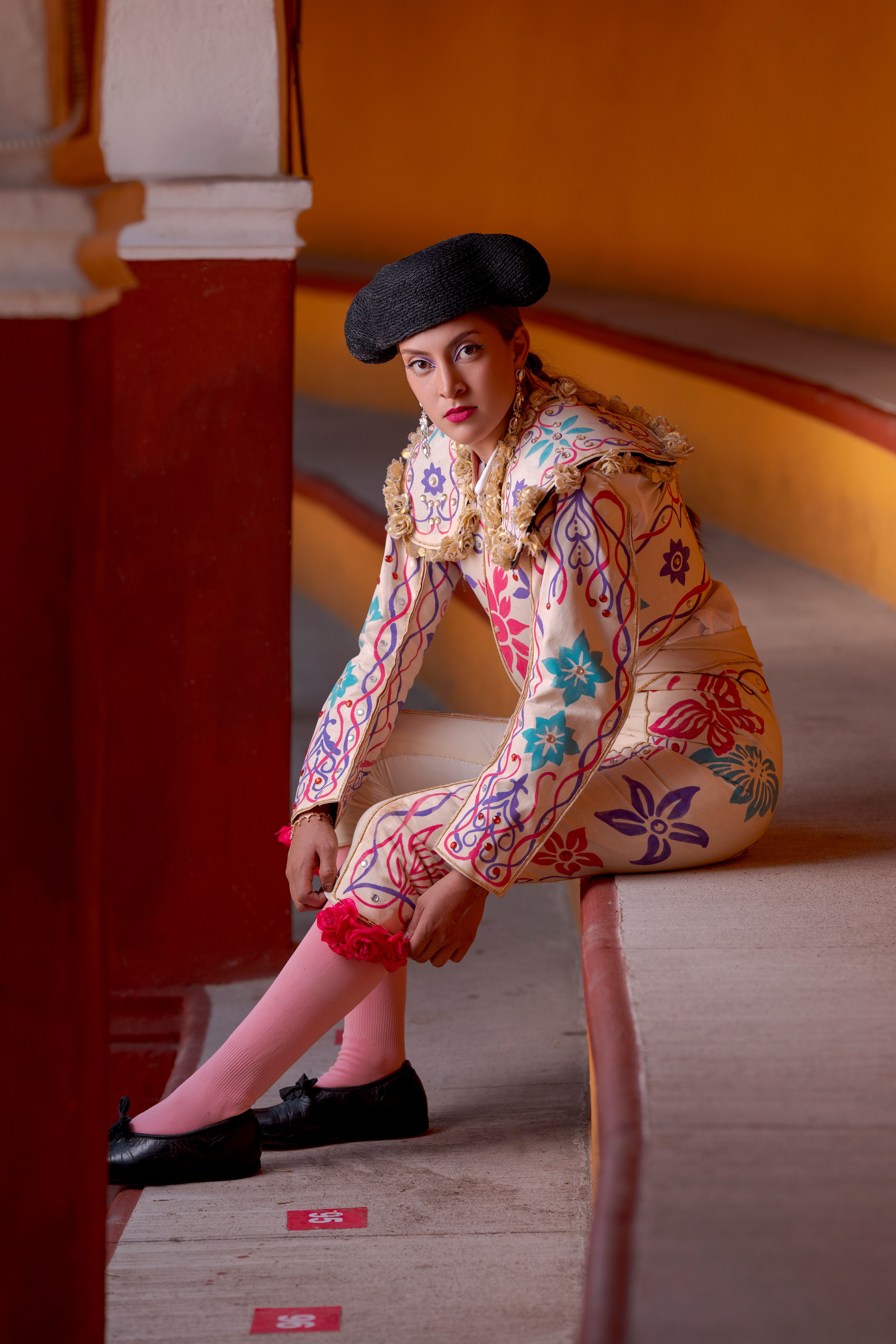 Vibrant portrait of a bullfighter in a traditional arena outfit, showcasing rich colors and traditional motifs.