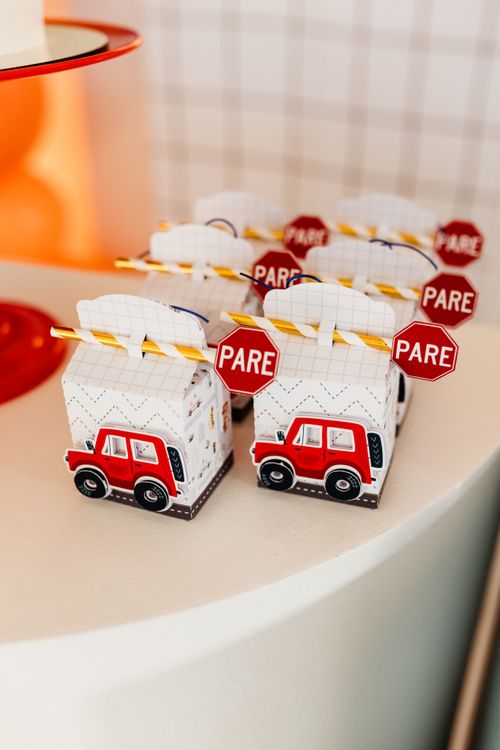 Free Playful party favor boxes designed as cars with 'PARE' stop signs, perfect for themed celebrations. Stock Photo