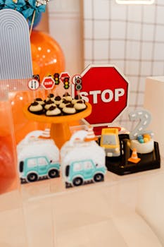 Vibrant birthday setup with traffic sign decor, toy cars, and party treats.