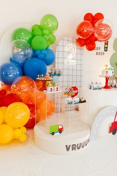 Vibrant kid's birthday party decor with balloons and toy cars. Perfect for a vibrant celebration.