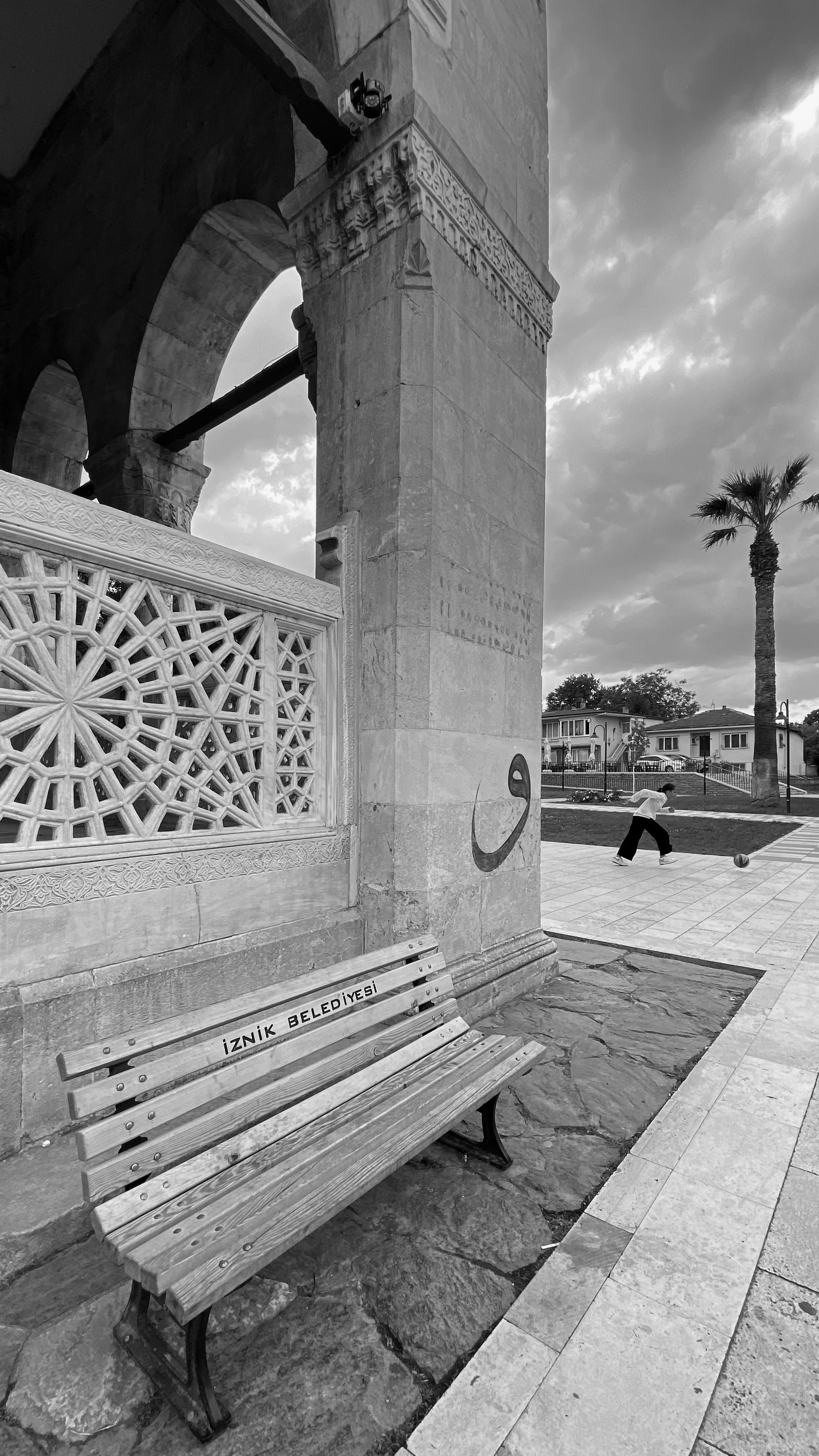 Black and white photo capturing intricate architecture with a serene park scene in Iznik.