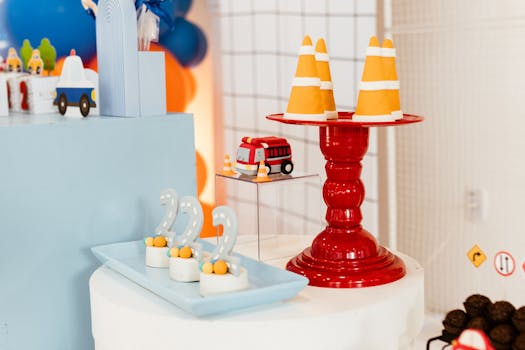 Vibrant birthday party setup with traffic cones and toy trucks for a child's celebration.