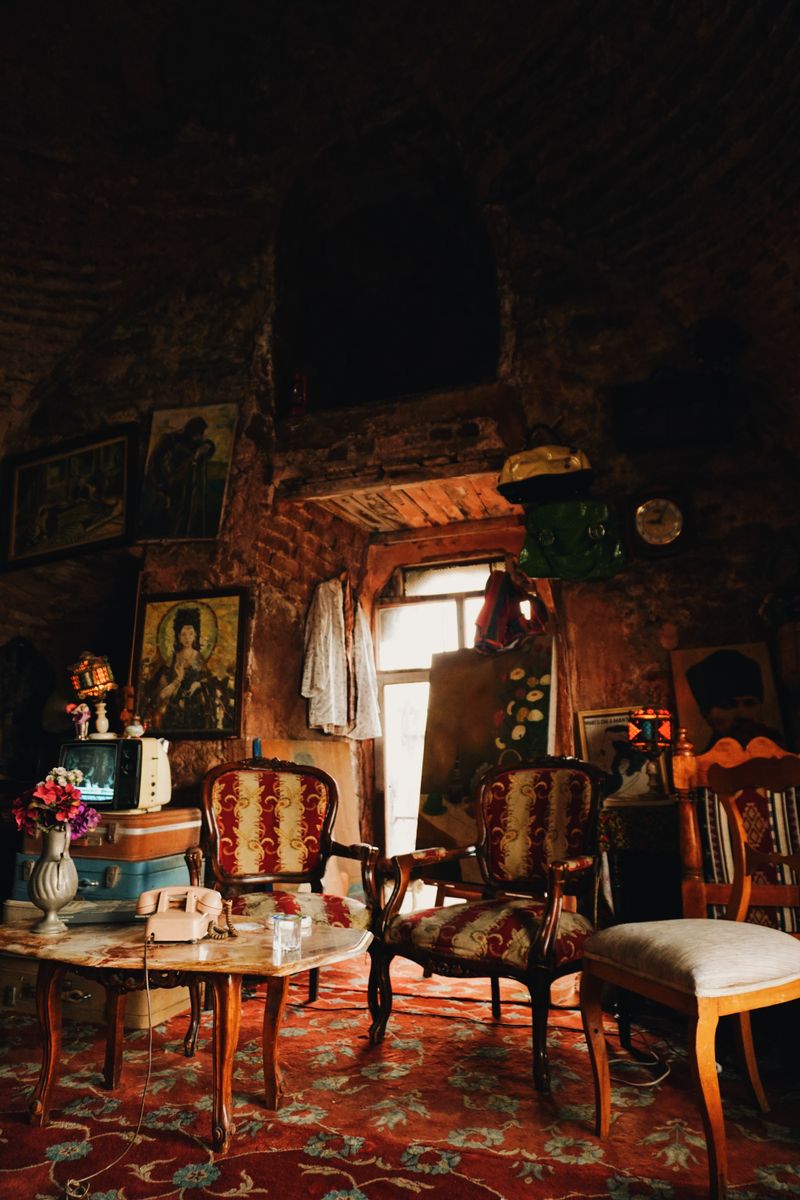 Antique shop interior with upholstered chairs and a carved table — photo by Nihat Kucuk on Pexels