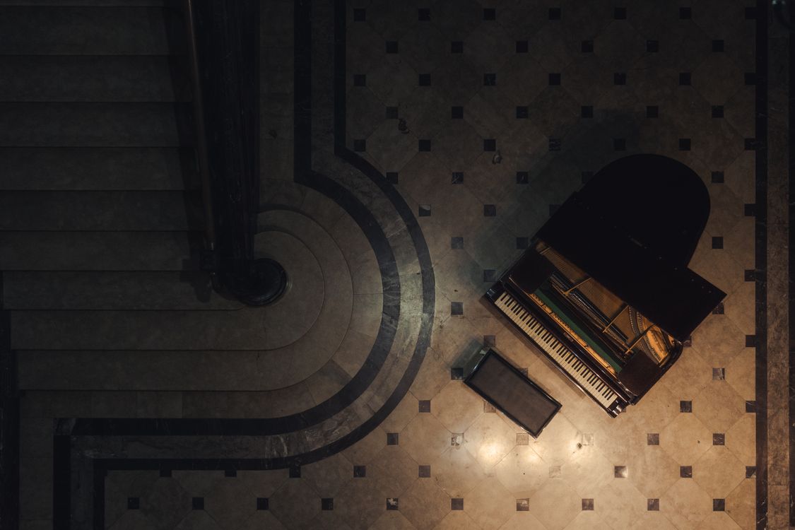 Aerial View of Grand Piano and Elegant Staircase · Free Stock Photo