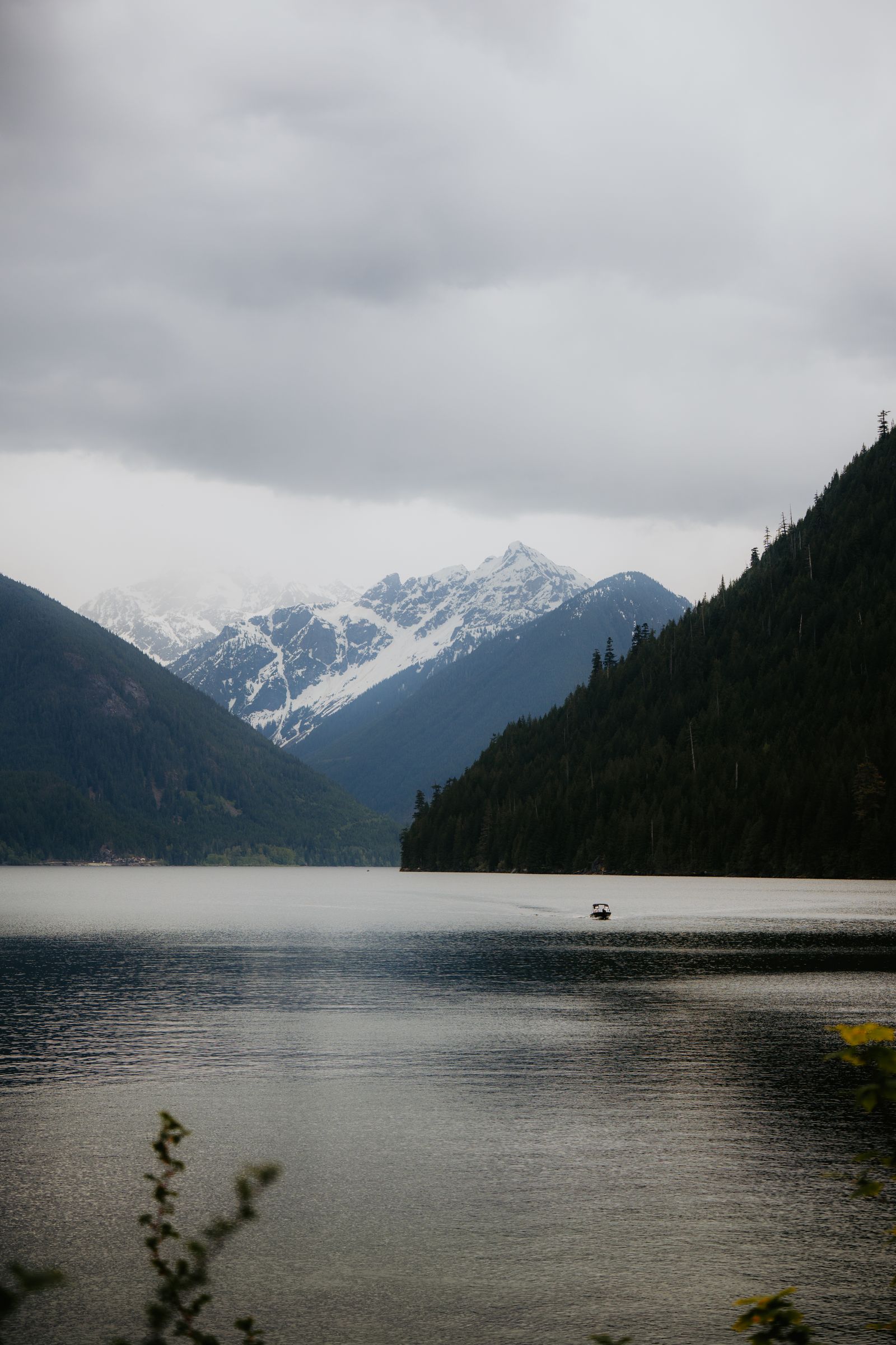 Crater Lake sits in a dramatic cirque with the spires of the Grenadier Range visible to the south