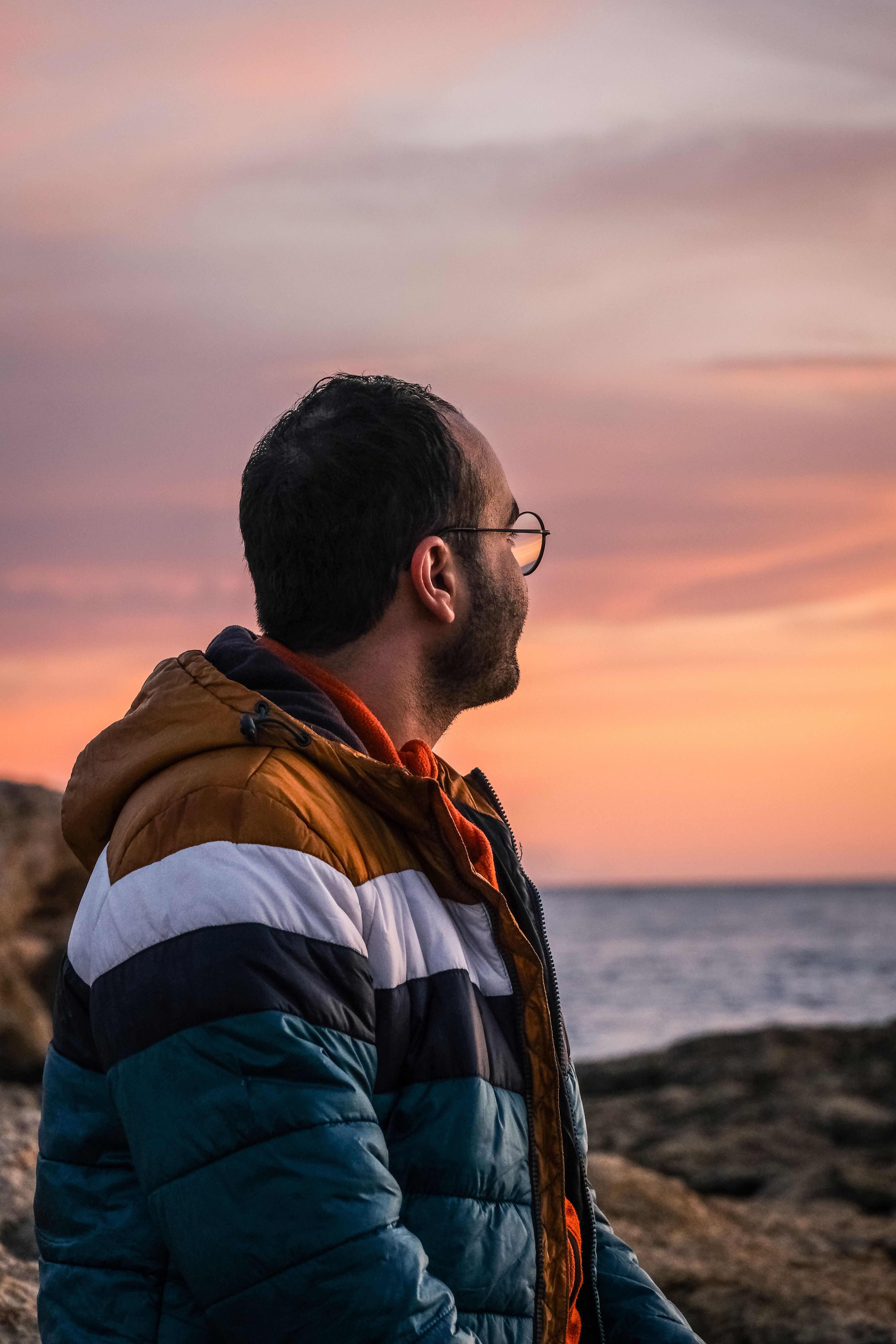 Man Contemplating Sunset by the Sea · Free Stock Photo