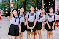 Teen Girls in Uniforms Enjoying Outdoors Evening