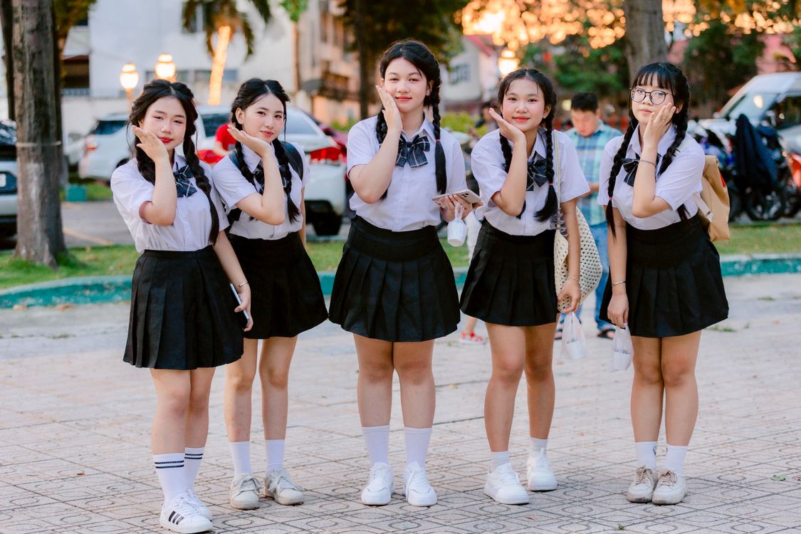 Teenage girls in school uniforms posing outdoors · Free Stock Photo