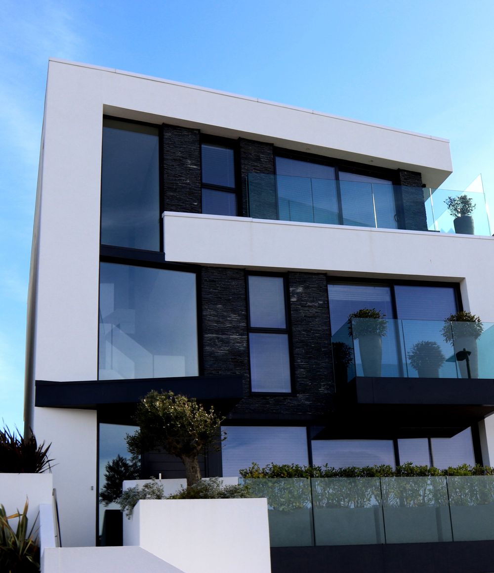 White and slate modern villa with glass balustrades