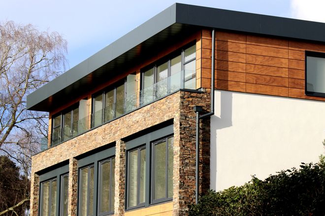 Contemporary house with a stone and timber facade and large windows — photo by Expect Best on Pexels