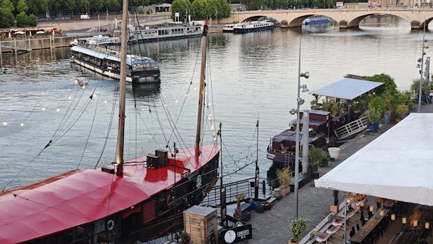 Picturesque scene of boats on the Seine River with a historic bridge in Paris.