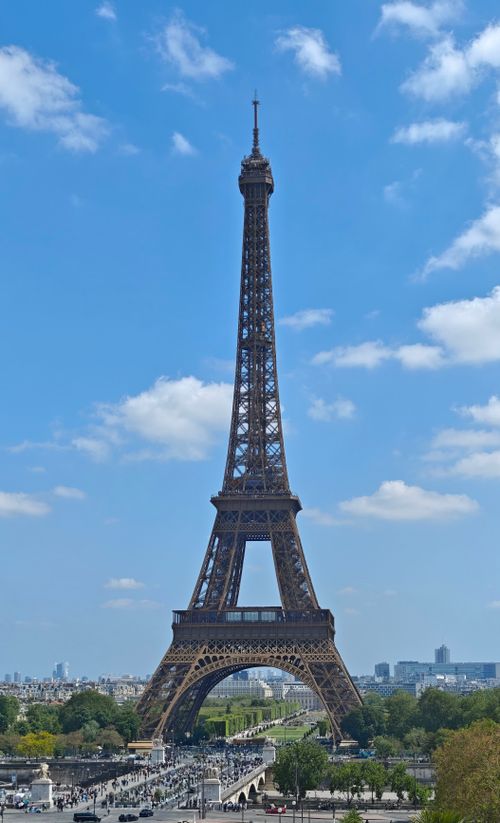 Free Stunning view of the Eiffel Tower under a clear blue sky, capturing its iconic architecture. Stock Photo
