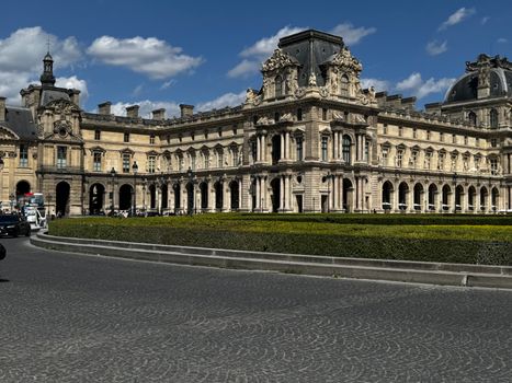 Captivating view of the historic Louvre Palace in Paris with clear blue skies and classic architecture.