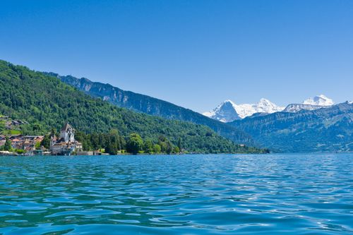 Free Serene Lake Thun with majestic Swiss Alps in the background. Stock Photo