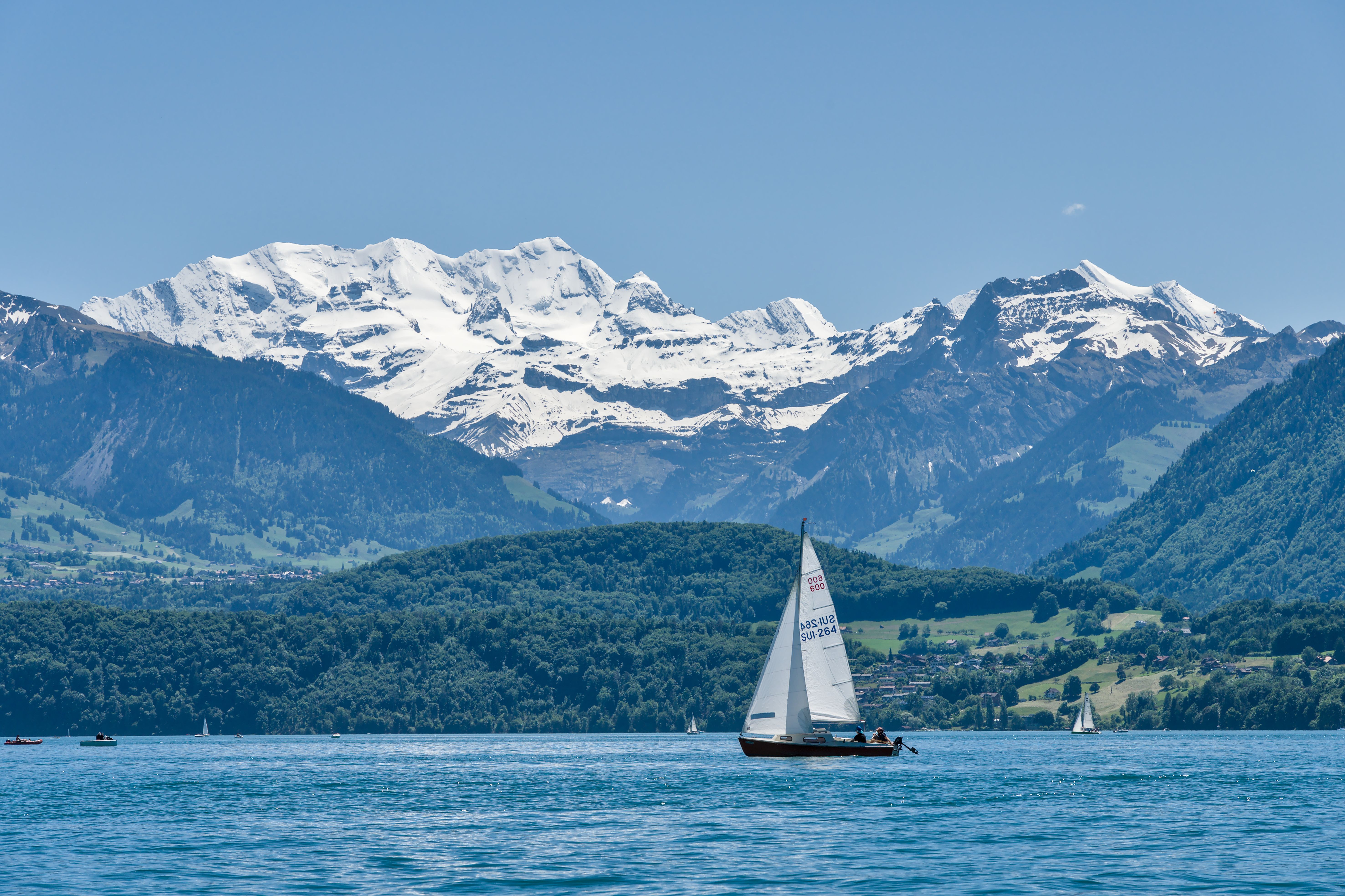 interlaken switzerland thun lake boat reflection mountains alps summer blue water