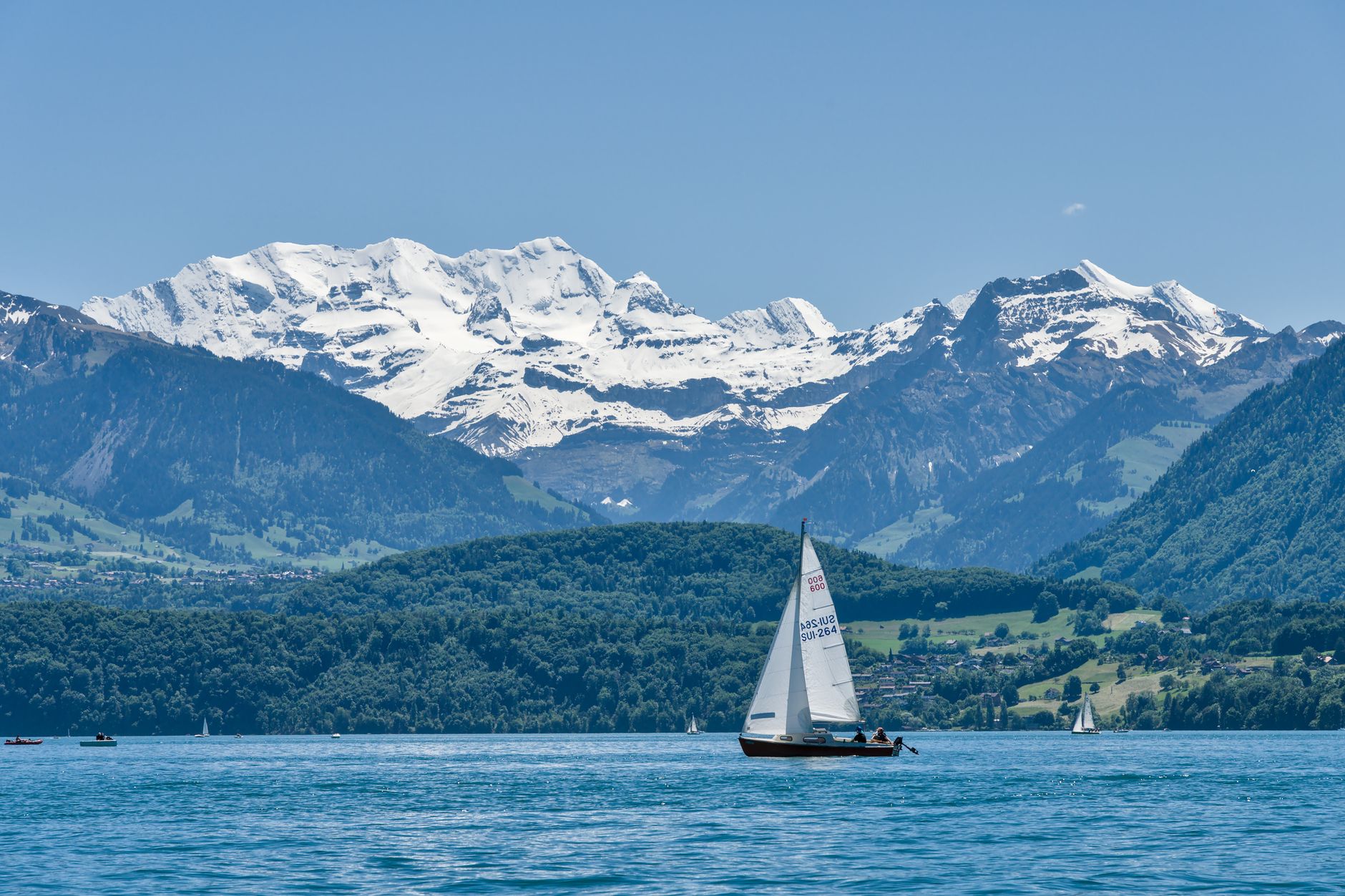 interlaken switzerland thun lake boat reflection mountains alps summer blue water