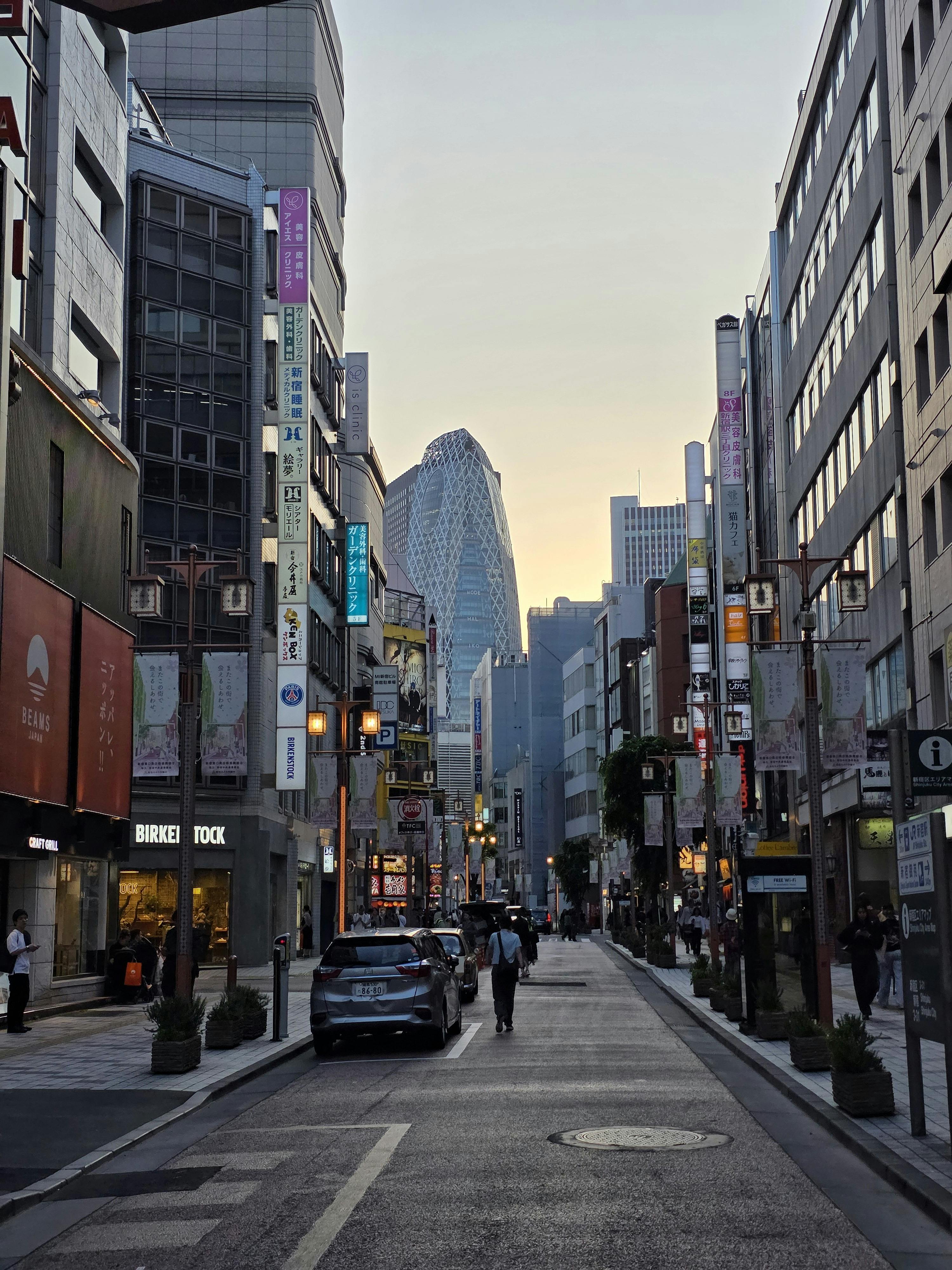 Free Evening street scene in Tokyo with modern skyscrapers and city life. Stock Photo