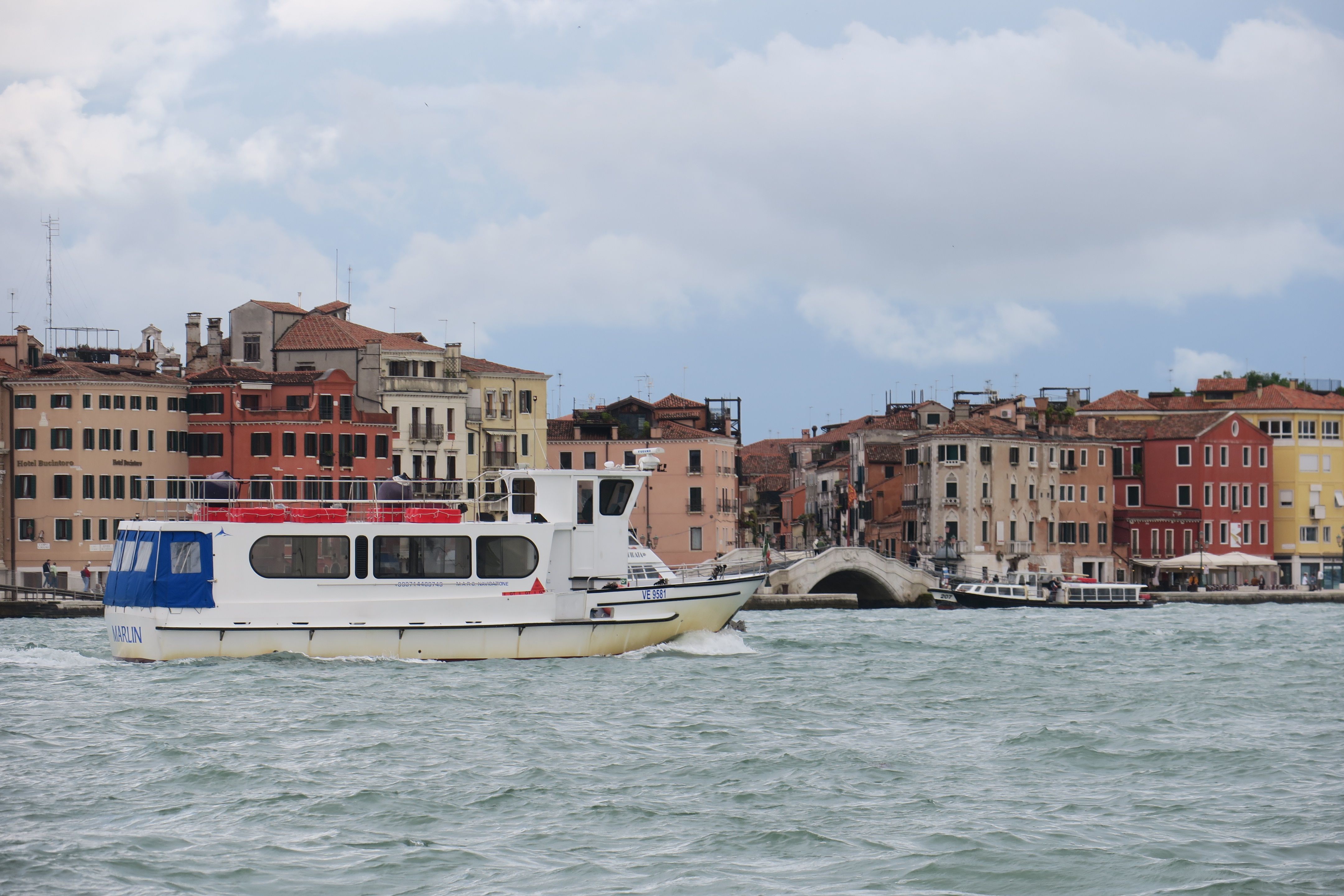Alilaguna water bus cruising through a canal in Venice