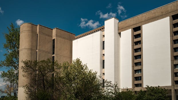 Contemporary building exterior with trees in Ankara, Türkiye under a clear blue sky.