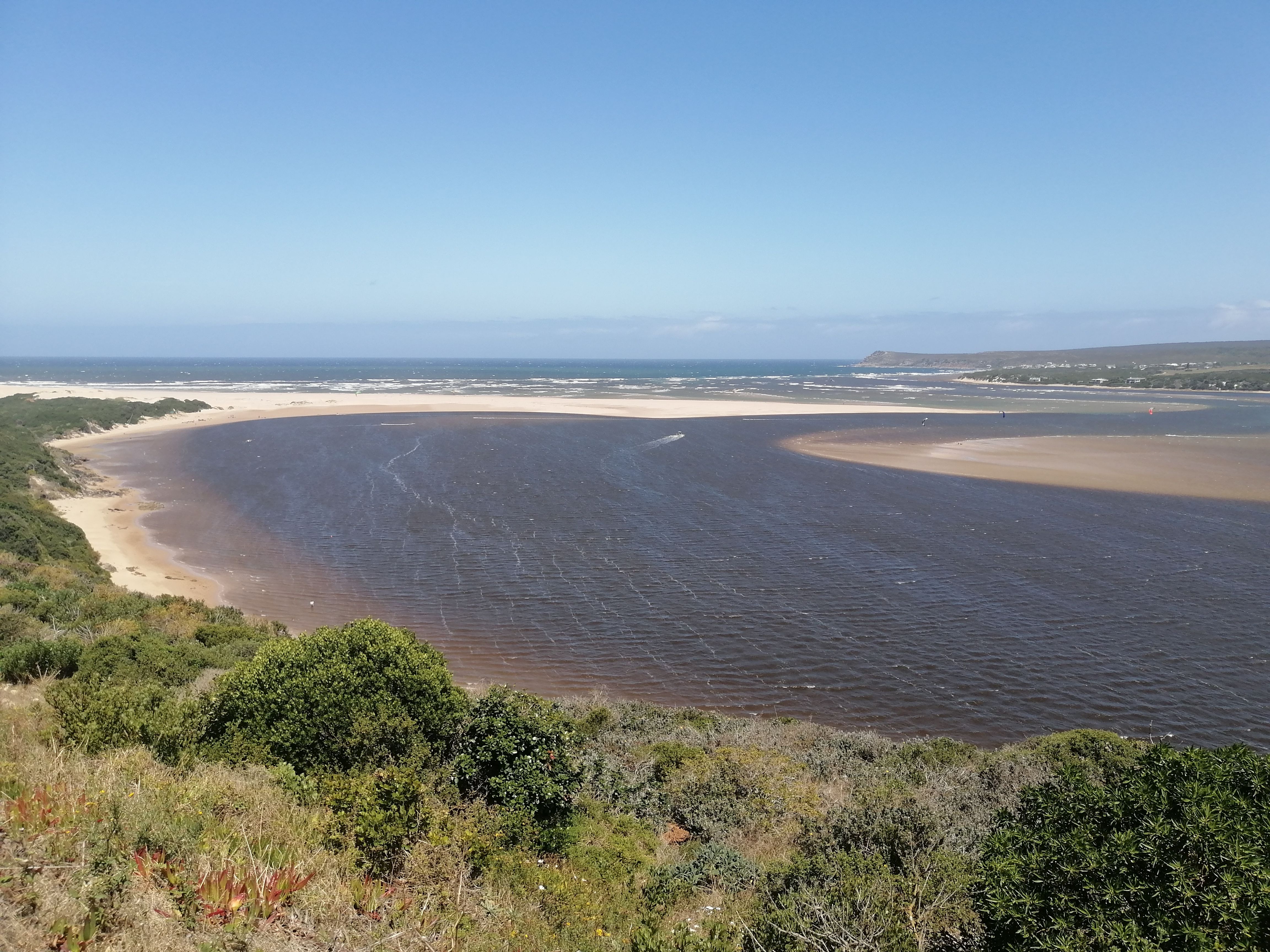 A breathtaking view of Witsand Beach, Western Cape, South Africa, showcasing a stunning coastal landscape under a clear blue sky.