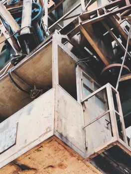 Close-up of an aged industrial crane with visible rust and worn metal parts.