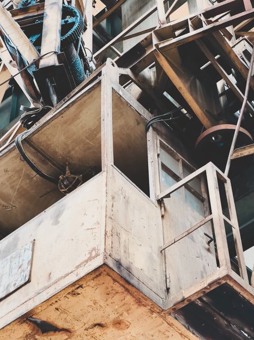 Free Close-up of an aged industrial crane with visible rust and worn metal parts. Stock Photo