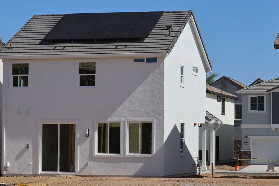 Newly constructed eco-friendly home in Elk Grove, CA, featuring rooftop solar panels for sustainable energy.