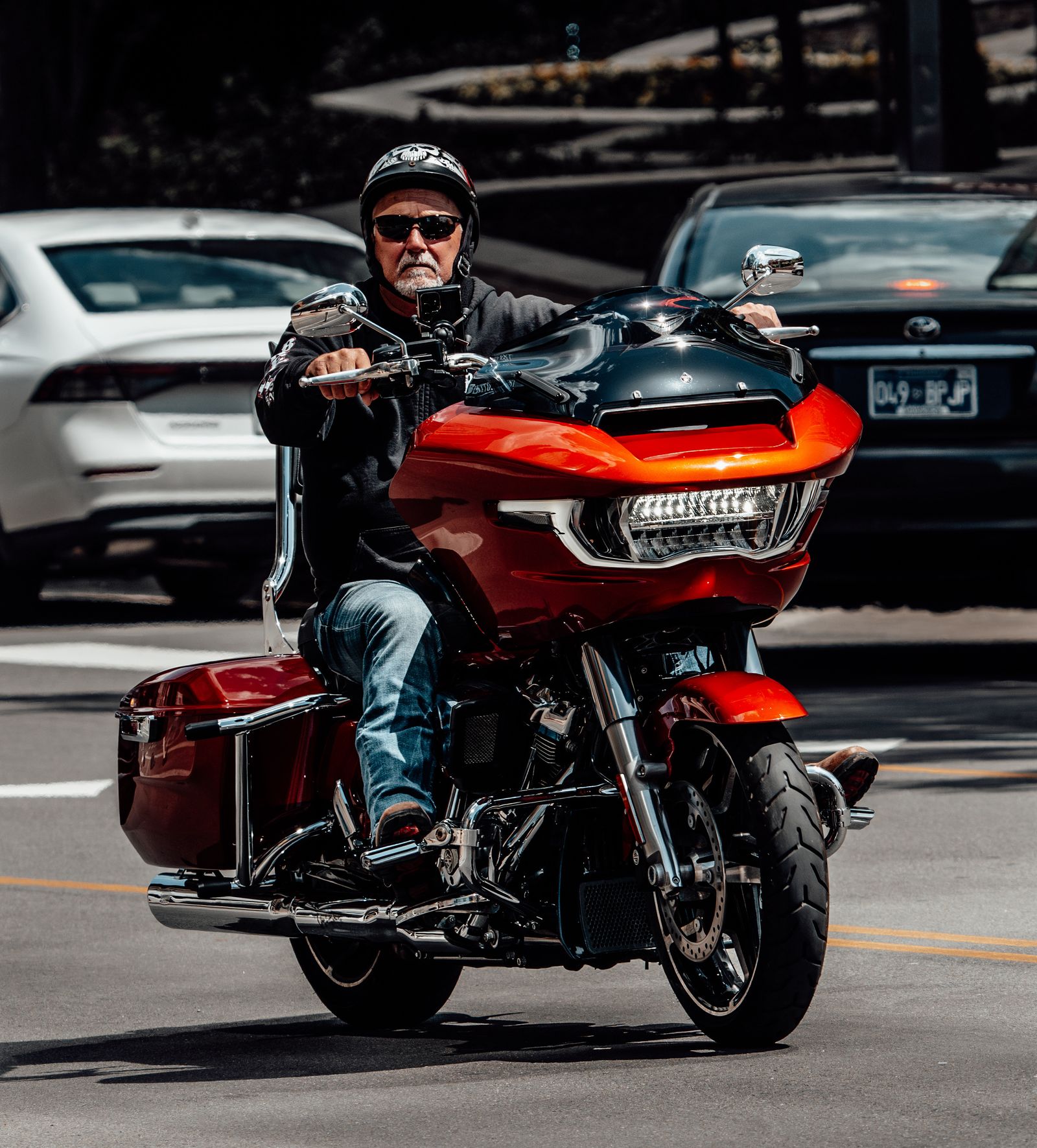 Motorcycle rider moving through a modern urban street