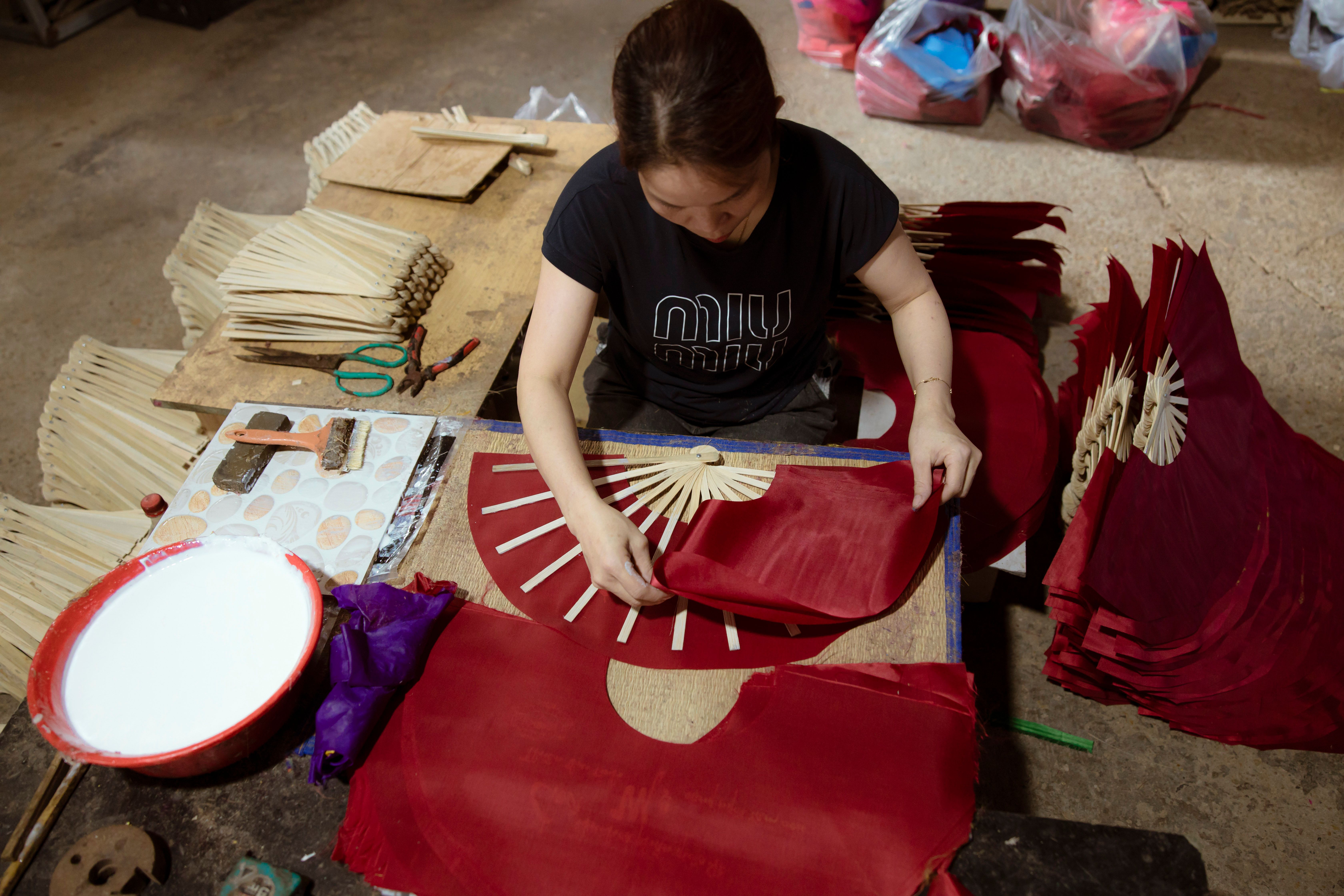 Artisan Crafting Traditional Paper Fans · Free Stock Photo