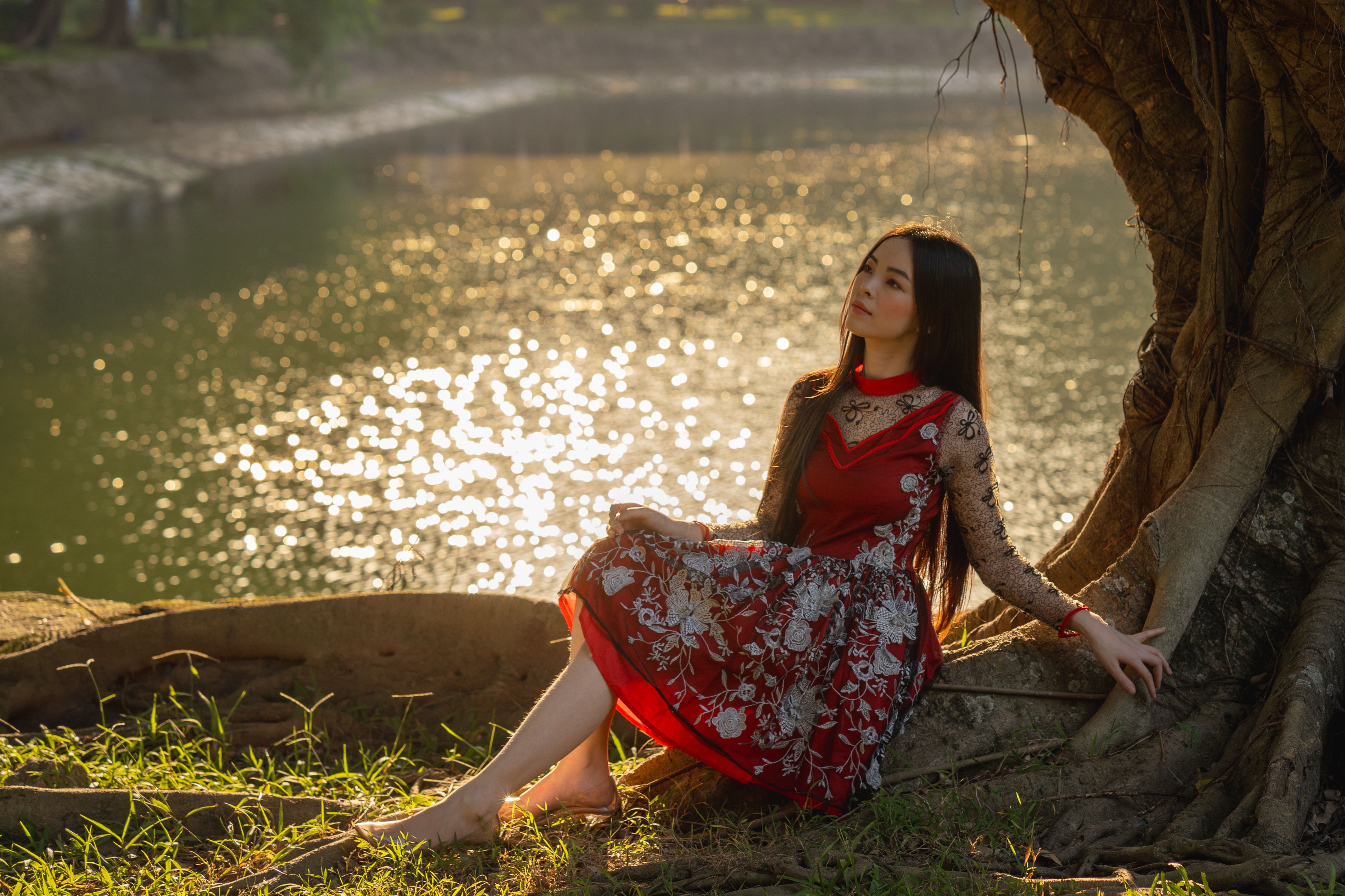 Elegant Woman in Red Dress by Sunlit Lake · Free Stock Photo