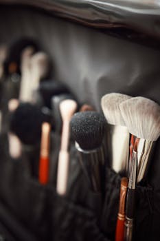Close-up of various makeup brushes in a holder for beauty and cosmetics professionals.