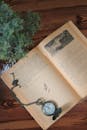 Open Vintage Book with Pocket Watch on Wooden Table