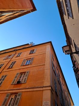 A fascinating view of historic French buildings against a blue sky in Nice.