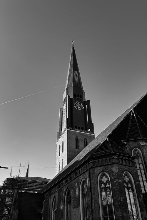 Free Striking black and white photo of a Gothic church tower, capturing intricate architectural details. Stock Photo