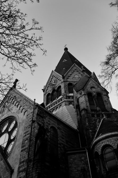Free Dramatic black and white photo of a Gothic church tower shot from below. Stock Photo
